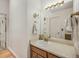 Neutral bathroom with wooden vanity and large mirror at 4198 Timbervale Dr, Evergreen, CO 80439