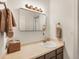 Bright bathroom with a stone countertop and a large vanity mirror and a sink at 4198 Timbervale Dr, Evergreen, CO 80439