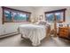 Bright bedroom with carpet flooring, neutral walls and rustic wood accents at 4198 Timbervale Dr, Evergreen, CO 80439