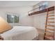 Bright bedroom with carpet flooring, white walls, and an accent ladder leading to a loft at 4198 Timbervale Dr, Evergreen, CO 80439