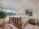 Bright bedroom with carpet flooring, white walls, and an accent wooden frame bed at 4198 Timbervale Dr, Evergreen, CO 80439