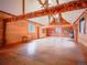 Large bonus room with wood-paneled walls, exposed beams, high ceilings, and natural light throughout the room at 4198 Timbervale Dr, Evergreen, CO 80439