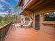 Spacious deck with outdoor seating, an umbrella, and a view of the surrounding landscape at 4198 Timbervale Dr, Evergreen, CO 80439
