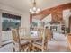 Dining room with rustic wood furnishings provides a view of the living room fireplace at 4198 Timbervale Dr, Evergreen, CO 80439