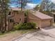 Attractive exterior view of a well-maintained home with a two-car garage and mature landscaping at 4198 Timbervale Dr, Evergreen, CO 80439