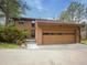 Side view of a well-maintained home showcasing an oversized attached two-car garage with a modern glass door design at 4198 Timbervale Dr, Evergreen, CO 80439