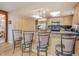 Bright eat-in kitchen features stainless appliances, wood cabinets, granite counters, and seating at 4198 Timbervale Dr, Evergreen, CO 80439
