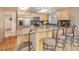 Light wood kitchen with stainless steel appliances, granite countertops, and seating at the island at 4198 Timbervale Dr, Evergreen, CO 80439
