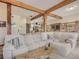Living room with exposed beams and cozy seating at 4198 Timbervale Dr, Evergreen, CO 80439
