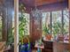Sunroom with wood walls, windows, and plants at 4198 Timbervale Dr, Evergreen, CO 80439