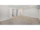 Spacious basement with carpet flooring, white walls, and access to additional rooms at 1111 Monroe St, Denver, CO 80206