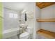 Modern bathroom with sleek fixtures, tiled shower/bath, and open shelving at 1111 Monroe St, Denver, CO 80206