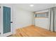 Bright bedroom with natural light, hardwood floors, and modern frosted glass door at 1111 Monroe St, Denver, CO 80206