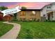 Charming brick home with a well-manicured lawn, inviting walkway, and an open house banner at 1111 Monroe St, Denver, CO 80206