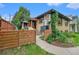 Exterior view of a brick home with a quaint front porch and well-maintained landscaping at 1111 Monroe St, Denver, CO 80206