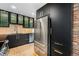Stylish kitchen boasts stainless steel appliances, sleek black cabinetry, and wood floors at 1111 Monroe St, Denver, CO 80206