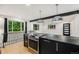 Modern kitchen featuring an island with an oven, pendant lighting, and views of the surrounding greenery at 1111 Monroe St, Denver, CO 80206