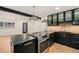 Sleek kitchen with a black island, stainless steel oven, and a view of the modern living area at 1111 Monroe St, Denver, CO 80206