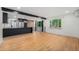 Bright open-concept living space with hardwood floors and a sleek modern kitchen with stainless steel appliances at 1111 Monroe St, Denver, CO 80206