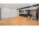 Spacious living room with hardwood floors, an open concept design, and a view of the modern kitchen at 1111 Monroe St, Denver, CO 80206