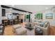 Cozy living room with an open floorplan, a modern kitchen, and scenic views from large windows at 1111 Monroe St, Denver, CO 80206