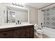 Updated bathroom with modern vanity, decorative tile, and shower/tub combo at 3335 S Ammons St # 103, Lakewood, CO 80227