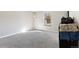 Bedroom showing neutral walls, gray carpet, and window for natural light at 3335 S Ammons St # 103, Lakewood, CO 80227