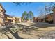 An exterior view of a community lawn surrounded by brick and wood buildings under a bright blue sky at 3335 S Ammons St # 103, Lakewood, CO 80227