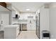 Modern kitchen with stainless steel appliances and white cabinets and countertop at 3335 S Ammons St # 103, Lakewood, CO 80227