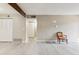 Spacious living room featuring a large window, modern flooring, and light fixtures at 3335 S Ammons St # 103, Lakewood, CO 80227