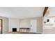 Bright living area with decorative fireplace, modern floors and a door at 3335 S Ammons St # 103, Lakewood, CO 80227