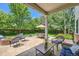 Covered patio with ample seating and a fire pit, perfect for outdoor entertaining at 13901 Quail Ridge Dr, Broomfield, CO 80020