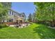 Expansive backyard with lush lawn, patio, and plenty of space for outdoor activities at 13901 Quail Ridge Dr, Broomfield, CO 80020