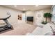 Finished basement with fitness equipment and beach themed decor at 13901 Quail Ridge Dr, Broomfield, CO 80020