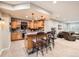 Basement bar features wood cabinets, tile backsplash, and seating for four at 13901 Quail Ridge Dr, Broomfield, CO 80020