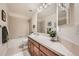 Well-maintained bathroom featuring a tiled countertop, updated fixtures, and a bathtub with shower, offering comfort and functionality at 13901 Quail Ridge Dr, Broomfield, CO 80020