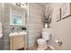 Modern half bathroom featuring stylish vanity, decorative wallpaper, and contemporary fixtures at 13901 Quail Ridge Dr, Broomfield, CO 80020