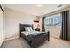 Cozy bedroom featuring a dark wood bed frame, neutral walls, large window, and plush carpeting, ideal for relaxation at 13901 Quail Ridge Dr, Broomfield, CO 80020