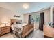 Serene bedroom featuring a light wood bed frame, neutral tones, and a bright window, creating a calming retreat at 13901 Quail Ridge Dr, Broomfield, CO 80020