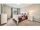 Comfortable bedroom featuring carpet, a window for natural light, and neutral-colored walls at 13901 Quail Ridge Dr, Broomfield, CO 80020