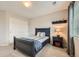 Well-lit bedroom with a dark wood bed frame, sliding closet doors, soft carpet, and a decorative shelf adding character at 13901 Quail Ridge Dr, Broomfield, CO 80020