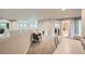 Open bonus room with neutral carpeting, a cozy chair, and plenty of natural light, ideal for versatile living at 13901 Quail Ridge Dr, Broomfield, CO 80020