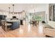 Bright kitchen with a center island, hardwood floors, stainless appliances, and an adjacent dining area at 13901 Quail Ridge Dr, Broomfield, CO 80020