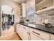 Kitchen detail featuring sleek countertops, subway tile backsplash, and ample cabinet space at 13901 Quail Ridge Dr, Broomfield, CO 80020