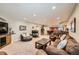 Spacious basement living room featuring a cozy fireplace, a bar area, and ample seating, ideal for entertaining guests at 13901 Quail Ridge Dr, Broomfield, CO 80020