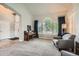 Cozy living room featuring large windows with modern shutters, natural light, and comfortable seating at 13901 Quail Ridge Dr, Broomfield, CO 80020