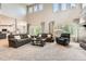Spacious living room boasts high ceilings, large windows, modern decor, and access to the kitchen at 13901 Quail Ridge Dr, Broomfield, CO 80020