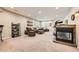 Expansive living room featuring a fireplace, plush carpeting, and abundant recessed lighting, perfect for relaxation and entertainment at 13901 Quail Ridge Dr, Broomfield, CO 80020