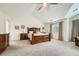 Tranquil main bedroom featuring a tray ceiling, neutral tones, and a large bed at 13901 Quail Ridge Dr, Broomfield, CO 80020