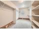 Large walk-in closet with custom shelving, wood trim, a window, and neutral-colored walls at 13901 Quail Ridge Dr, Broomfield, CO 80020